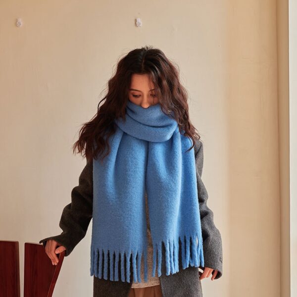Model wearing the blue wool scarf