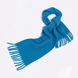 Blue wool scarf with fringed ends on a white background