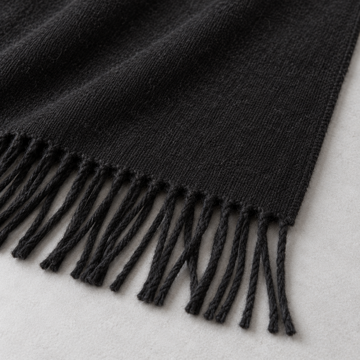 RUISONG Black wool scarf — fabric and fringe detail RUISONG Black wool scarf — fabric and fringe detail