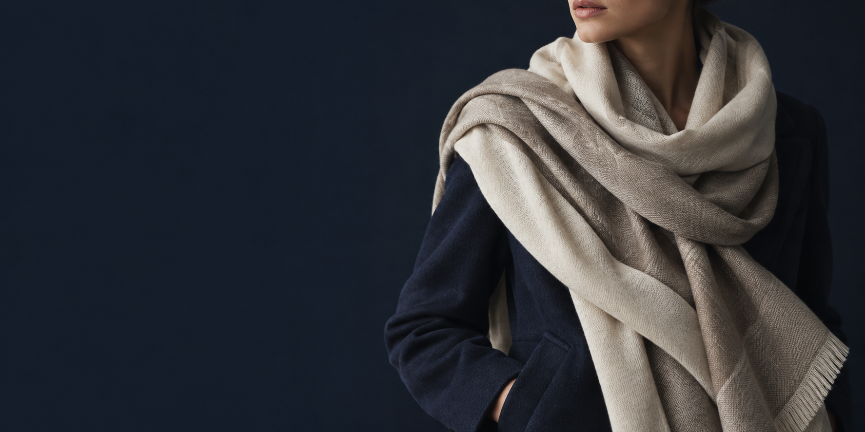 Editorial scarf styling with a navy coat; a collection preview, not a product listing